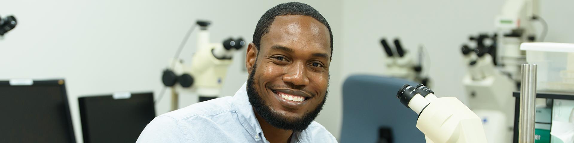 Sean working at his microscope in the lab